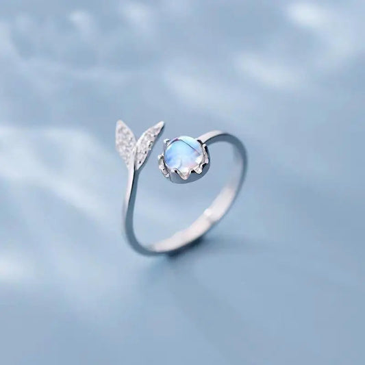Adjustable ring with dolphin tail made of sterling silver and blue zirconium dioxide